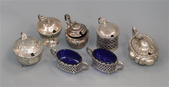 Five assorted silver mustards and a pair of silver salts.